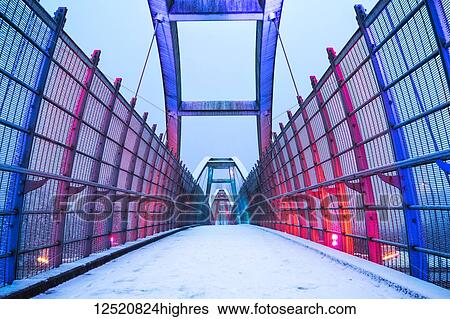 A walking bridge covered with snow and illuminated with red light; Surrey, British Columbia, Canada View Large Photo Image Stock Photograph - A walking bridge covered with snow and illuminated with red light; Surrey, British Columbia, Canada. Fotosearch