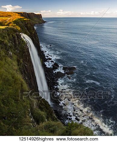 A waterfall flowing over a cliff along the coastline; Isle of Skye, Scotland View Large Photo Image Stock Photograph - A waterfall flowing over a cliff along the coastline; Isle of Skye, Scotland. Fotosearch