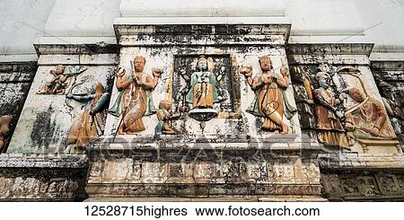 Stock Photograph - A weathered wall decorated with traditional Indian and Hindu figures; Rishikesh, Uttarakhand, India. Fotosearch