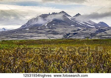 Stock Photograph - A wide angle view hiking the plateau trails towards the dormant volcano at Vatnajokull National Park; Iceland. Fotosearch