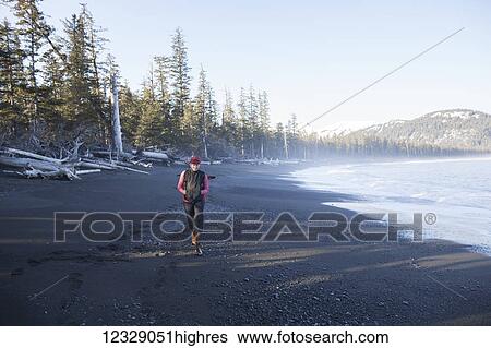 A woman walking on the beach, Kenai Peninsula outer coast; Alaska, United States of America View Large Photo Image Stock Photograph - A woman walking on the beach, Kenai Peninsula outer coast; Alaska, United States of America. Fotosearch