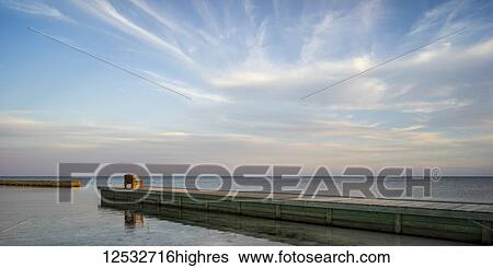 A wooden bench at the end of a dock facing the open ocean at sunrise; Belize View Large Photo Image Stock Photograph - A wooden bench at the end of a dock facing the open ocean at sunrise; Belize. Fotosearch