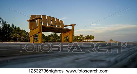 A wooden bench on a dock with palm trees along the coast; Belize View Large Photo Image Stock Photograph - A wooden bench on a dock with palm trees along the coast; Belize. Fotosearch