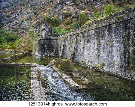 A worn stone wall with cascading water along the Bay of Kotor; Kotor, Monte View Large Photo Image Stock Photograph - A worn stone wall with cascading water along the Bay of Kotor; Kotor, Monte. Fotosearch