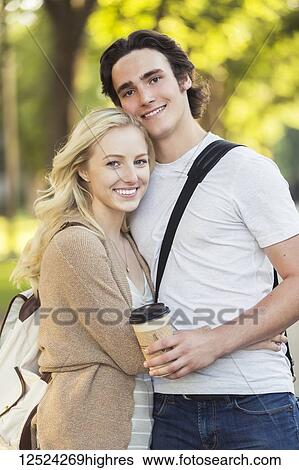 A young couple shares a romantic moment together in an embrace while outside on the university campus; Edmonton, Alberta, Canada View Large Photo Image Stock Photograph - A young couple shares a romantic moment together in an embrace while outside on the university campus; Edmonton, Alberta, Canada. Fotosearch