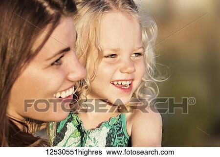 A young mother and her cute young daughter spending quality time together in a park on a warm evening during the fall season; Spruce Grove, Alberta, Canada View Large Photo Image Stock Photograph - A young mother and her cute young daughter spending quality time together in a park on a warm evening during the fall season; Spruce Grove, Alberta, Canada. Fotosearch