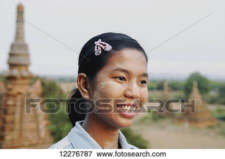 A young woman smiling with a temple in the background; Bagan, Myanmar View Large Photo Image Stock Photo - A young woman smiling with a temple in the background; Bagan, Myanmar. Fotosearch