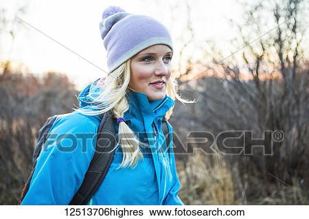 A young women carrying a backpack and walking at sunrise; Anchorage, Alaska, United States of America View Large Photo Image Stock Photograph - A young women carrying a backpack and walking at sunrise; Anchorage, Alaska, United States of America. Fotosearch