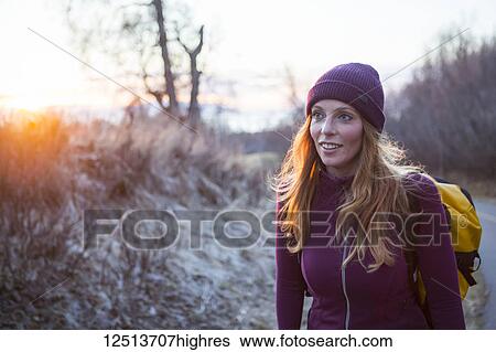 A young women carrying a backpack and walking at sunrise; Anchorage, Alaska, United States of America View Large Photo Image Stock Photograph - A young women carrying a backpack and walking at sunrise; Anchorage, Alaska, United States of America. Fotosearch
