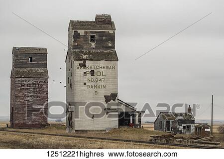 Stock Photograph - Abandoned grain elevators in rural Saskatchewan; Saskatchewan, Canada. Fotosearch