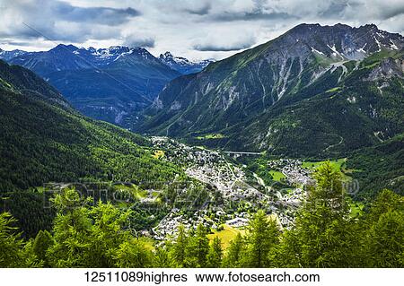 Aerial view of Courmayeur city surrounded by mountains; Courmayeur, Aosta Valley, Italy View Large Photo Image Stock Photograph - Aerial view of Courmayeur city surrounded by mountains; Courmayeur, Aosta Valley, Italy. Fotosearch