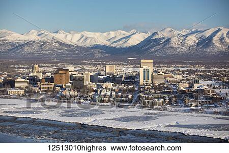 Aerial view of snow covering downtown Anchorage and the Chugach Mountains in the distance, Cook Inlet in the foreground, South-central Alaska in winter; Anchorage, Alaska, United States of America View Large Photo Image Stock Photograph - Aerial view of snow covering downtown Anchorage and the Chugach Mountains in the distance, Cook Inlet in the foreground, South-central Alaska in winter; Anchorage, Alaska, United States of America. Fotosearch