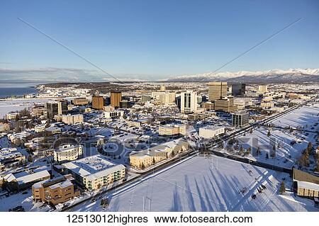 Aerial view of snow covering downtown Anchorage and the Chugach and Talkeetna Mountains stretching out behind the city in the distance, the Park Strip visible in the foreground, South-central Alaska in winter; Anchorage, Alaska, United States of America View Large Photo Image Stock Photograph - Aerial view of snow covering downtown Anchorage and the Chugach and Talkeetna Mountains stretching out behind the city in the distance, the Park Strip visible in the foreground, South-central Alaska in winter; Anchorage, Alaska, United States of America. Fotosearch