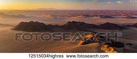 Aerial view of the sand dunes of the Namib Desert at sunrise; Sossusvlei, Hardap Region, Namibia View Large Photo Image Stock Photograph - Aerial view of the sand dunes of the Namib Desert at sunrise; Sossusvlei, Hardap Region, Namibia. Fotosearch
