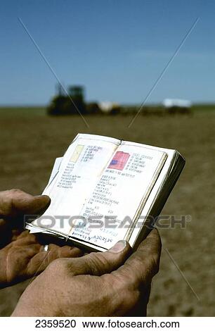 Agriculture - A farmer checks his field report pocket notebook during spring planting operations / Midwest USA. View Large Photo Image Stock Image - Agriculture - A farmer checks his field report pocket notebook during spring planting operations / Midwest USA.. Fotosearch