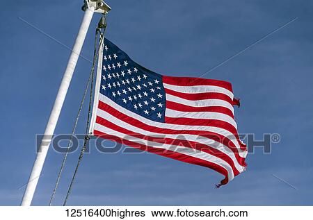 Stock Photograph - American flag flying at the stern of the Alaska Marine Highway System ferry MV LeConte between Juneau and Gustavus, Alaska; Alaska, United States of America. Fotosearch