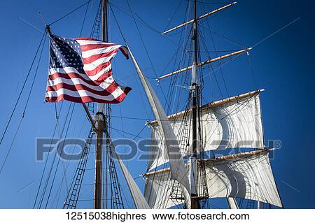 American flag hanging on a sailboat against a blue sky; San Diego, California, United States of America View Large Photo Image Stock Photograph - American flag hanging on a sailboat against a blue sky; San Diego, California, United States of America. Fotosearch