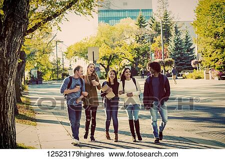 An ethnically diverse group of university students walk and talk together on the campus in autumn; Edmonton, Alberta, Canada View Large Photo Image Stock Photograph - An ethnically diverse group of university students walk and talk together on the campus in autumn; Edmonton, Alberta, Canada. Fotosearch