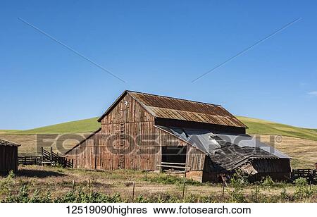 Stock Photograph - An old, decrepit barn with a failing roof, Eastern Washington; Dayton, Washington, United States of America. Fotosearch