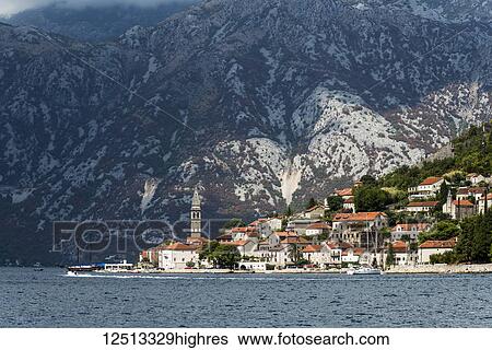 Stock Photograph - Bay of Kotor with buildings in the city of Perast along the coastline; Perast, Kotor Municipality, Monte. Fotosearch