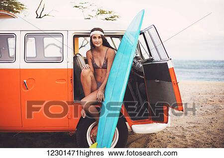 Stock Photograph - Beach Lifestyle, Beautiful Surfer Girl With Classic Vintage Surf Van On The Beach At Sunset. Fotosearch