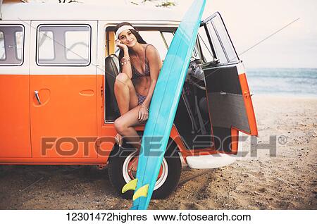 Stock Photograph - Beach Lifestyle, Beautiful Surfer Girl With Classic Vintage Surf Van On The Beach At Sunset. Fotosearch