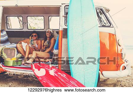 Beach Lifestyle. Beautiful Young Surfer Girls Having Fun Hanging Out In Vintage Surf Van. Best Friends. View Large Photo Image Stock Photograph - Beach Lifestyle. Beautiful Young Surfer Girls Having Fun Hanging Out In Vintage Surf Van. Best Friends.. Fotosearch