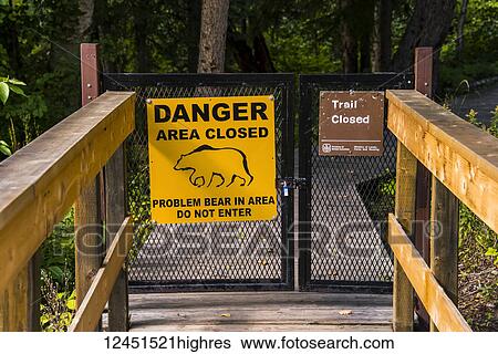 Bear warning sign posted on a closed gate where a trail has been closed, Liard River Hot Springs Provincial Park; British Columbia, Canada View Large Photo Image Stock Photograph - Bear warning sign posted on a closed gate where a trail has been closed, Liard River Hot Springs Provincial Park; British Columbia, Canada. Fotosearch