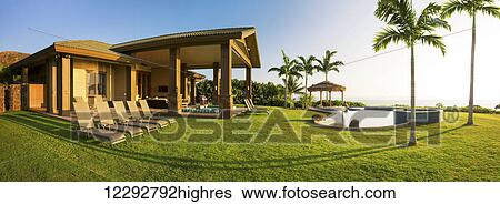 Stock Photograph - Beautiful Home With Large Grassy Green Lawn And Pool. Fotosearch