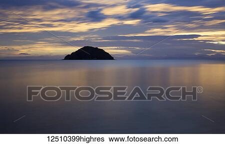 Beautiful sunrise reflected in the tranquil waters of the Pacific Ocean, Abel Tasman National Park; Nelson, New Zealand View Large Photo Image Stock Photograph - Beautiful sunrise reflected in the tranquil waters of the Pacific Ocean, Abel Tasman National Park; Nelson, New Zealand. Fotosearch