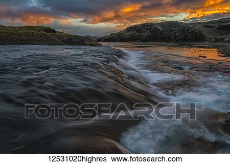 Stock Photograph - Beautiful sunset over a stream in rural Iceland; Iceland. Fotosearch