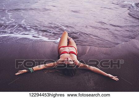 Beautiful Woman Relaxing On Tropical Beach At Sunset View Large Photo Image Stock Photograph - Beautiful Woman Relaxing On Tropical Beach At Sunset. Fotosearch