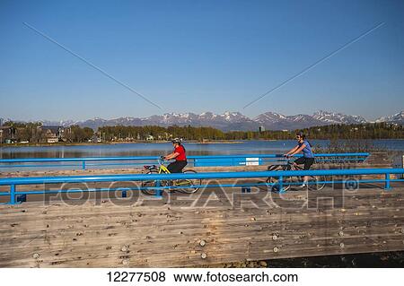 Bicyclist on the Tony Knowels Coastal Trail near Westchester Lagoon in Anchorage, Alaska, Spring. View Large Photo Image Stock Photo - Bicyclist on the Tony Knowels Coastal Trail near Westchester Lagoon in Anchorage, Alaska, Spring.. Fotosearch