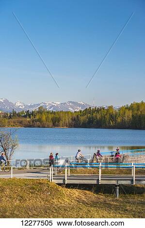 Bicyclist on the Tony Knowels Coastal Trail near Westchester Lagoon in Anchorage, Alaska, Spring. View Large Photo Image Stock Photography - Bicyclist on the Tony Knowels Coastal Trail near Westchester Lagoon in Anchorage, Alaska, Spring.. Fotosearch