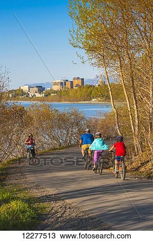 Bicyclists on the Tony Knowles Coastal Trail near downtown Anchorage, Alaska, Spring View Large Photo Image Stock Image - Bicyclists on the Tony Knowles Coastal Trail near downtown Anchorage, Alaska, Spring. Fotosearch