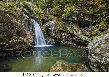 Stock Photograph - Bingham Falls with foliage on the rugged rocks, Green Mountains; Stowe, Vermont, United States of America. Fotosearch
