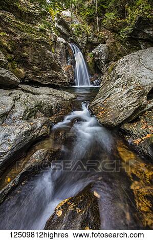 Stock Photograph - Bingham Falls with foliage on the rugged rocks, Green Mountains; Stowe, Vermont, United States of America. Fotosearch