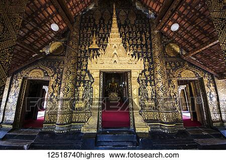 Stock Photograph - Black and gold stencilled columns on the portico of the sim (congregation hall) of Wat Xieng Thong; Luang Prabang, Laos. Fotosearch