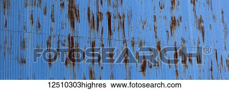 Stock Photograph - Blue tin wall with rust markings; Montreal, Quebec, Canada. Fotosearch