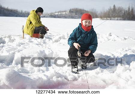 Boy ice fishing on Matanuska Lake in the Matanuska Valley north of Anchorage, Southcentral Alaska View Large Photo Image Picture - Boy ice fishing on Matanuska Lake in the Matanuska Valley north of Anchorage, Southcentral Alaska. Fotosearch
