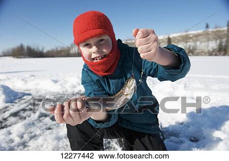 Stock Image - Boy ice fishing on Matanuska Lake in the Matanuska Valley north of Anchorage, Southcentral Alaska. Fotosearch