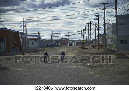 Boys on bikes on a street; Cambridge Bay, Nunavut, Canada View Large Photo Image Stock Photography - Boys on bikes on a street; Cambridge Bay, Nunavut, Canada. Fotosearch