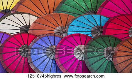 Stock Photograph - Bright coloured paper umbrellas for sale at the night market; Luang Prabang, Luang Prabang, Laos. Fotosearch