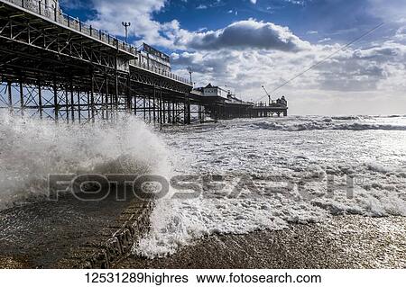 Brighton Palace Pier with waves crashing onto shore; Brighton, Sussex, England View Large Photo Image Stock Photograph - Brighton Palace Pier with waves crashing onto shore; Brighton, Sussex, England. Fotosearch