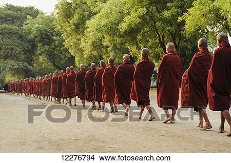Buddhist monks walking barefoot down a road in a row; Myanmar View Large Photo Image Picture - Buddhist monks walking barefoot down a road in a row; Myanmar. Fotosearch