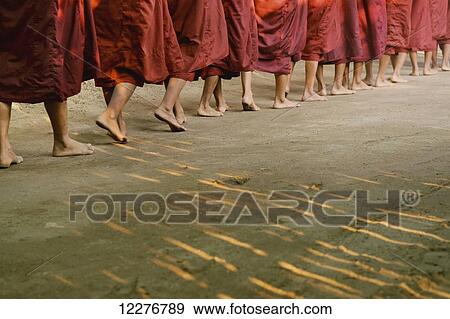 Buddhist monks walking in a row in bare feet; Bagan, Myanmar View Large Photo Image Stock Photo - Buddhist monks walking in a row in bare feet; Bagan, Myanmar. Fotosearch