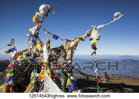 Stock Photograph - Buddhist prayer flags at the summit of Pikey Peak in the Himalayas; Nepal. Fotosearch