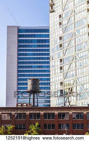 Buildings in downtown Chicago with a water reservoir on the rooftop of a residential building, showing the contrast of old and new buildings; Chicago, Illinois, United States of America View Large Photo Image Stock Photograph - Buildings in downtown Chicago with a water reservoir on the rooftop of a residential building, showing the contrast of old and new buildings; Chicago, Illinois, United States of America. Fotosearch