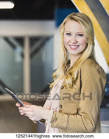 Business portrait of a beautiful young millennial professional using technology in the workplace; Sherwood Park, Alberta, Canada View Large Photo Image Stock Photograph - Business portrait of a beautiful young millennial professional using technology in the workplace; Sherwood Park, Alberta, Canada. Fotosearch