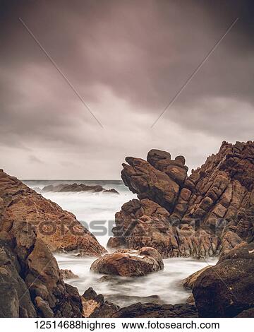 Stock Photograph - Canal rocks along the coast of the Indian Ocean under a cloudy sky; Yallingup, Western Australia, Australia. Fotosearch